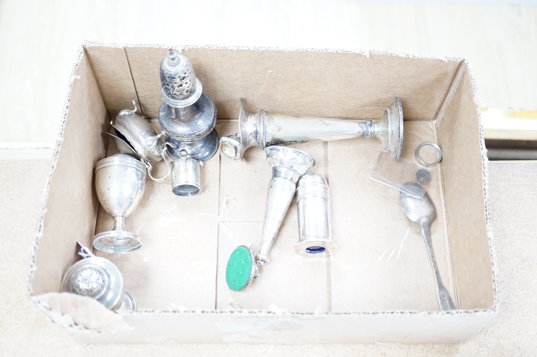 A quantity of silver items including a late Victorian repousse photograph frame, William Comyns, London, 1899, 20cm, three Georgian pepperettes, pair of small Armada dishes, quaich, vest case, menu holder, basting spoons